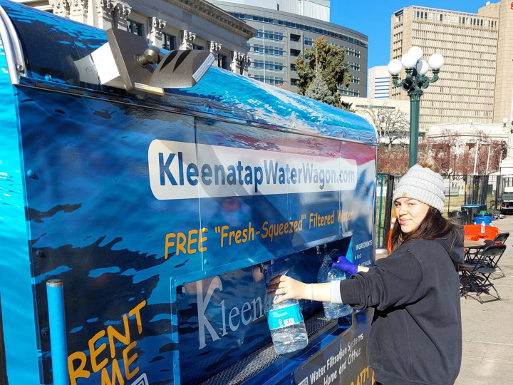 Kleanatap Water Wagon and a woman pouring herself a glass